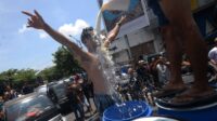 Peloper susu melakukan aksi mandi susu sapi yang tidak terserap oleh industri pengolahan susu di Tugu Susu Tumpah, Boyolali, Jawa Tengah